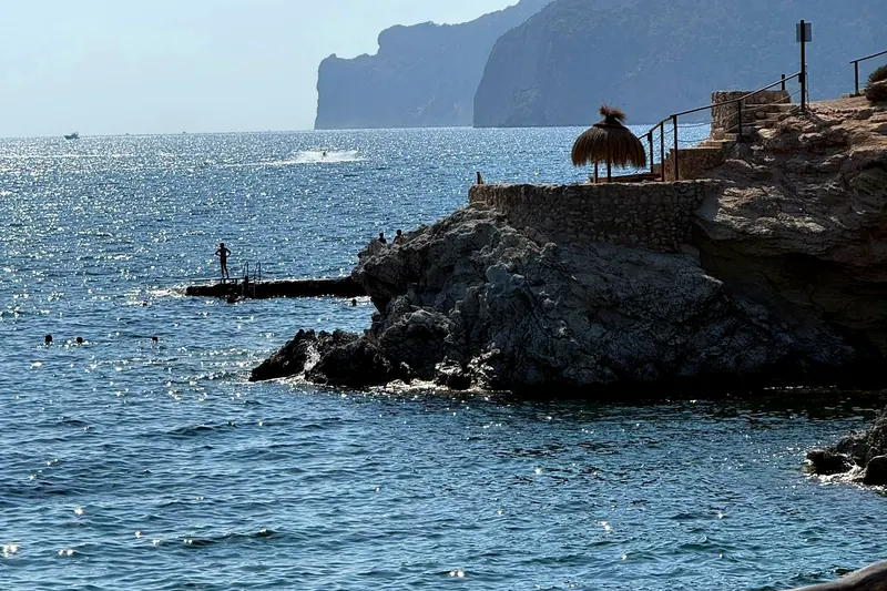 Pool and beds on a rock terrace by the sea