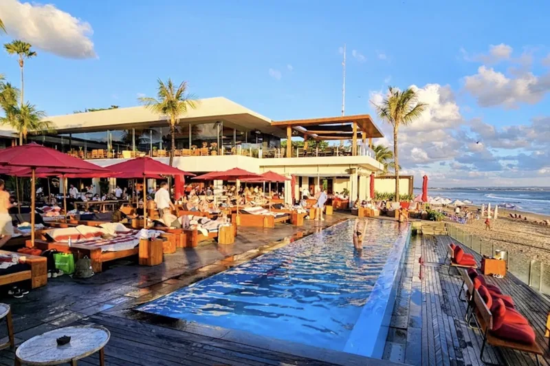 The long pool and red umbrellas at Ku De Ta, Seminyak
