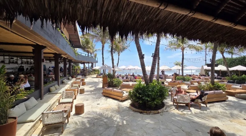 The thatched pavilion and daybeds at The Lawn, looking out to Batu Bolong