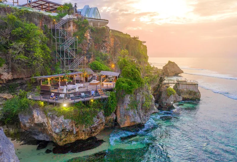 The lower deck at Ulu Cliffhouse, out on the rock above the Uluwatu water, at sunset