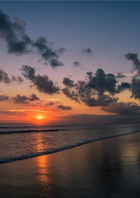 Sunset reflected on the wet sand, west coast