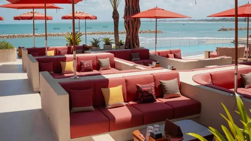 Main deck sofas at Zumana Beach Club with the pool and the sea beyond