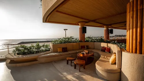 An ocean-edge sofa at Zumana Beach Club looking down Kuta Beach