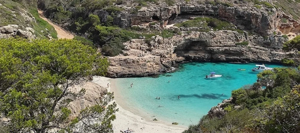 The pale sand and turquoise water of Es Caló des Màrmols on Mallorca&rsquo;s south-east coast