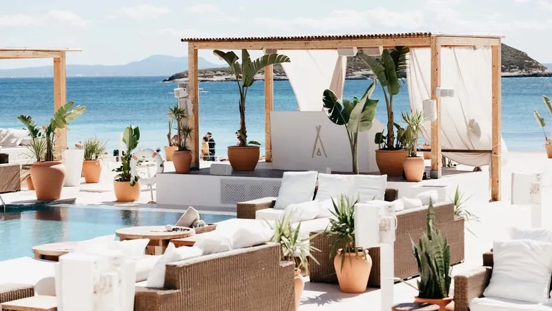 White sofas and cabanas on the sand at Nikki Beach Mallorca